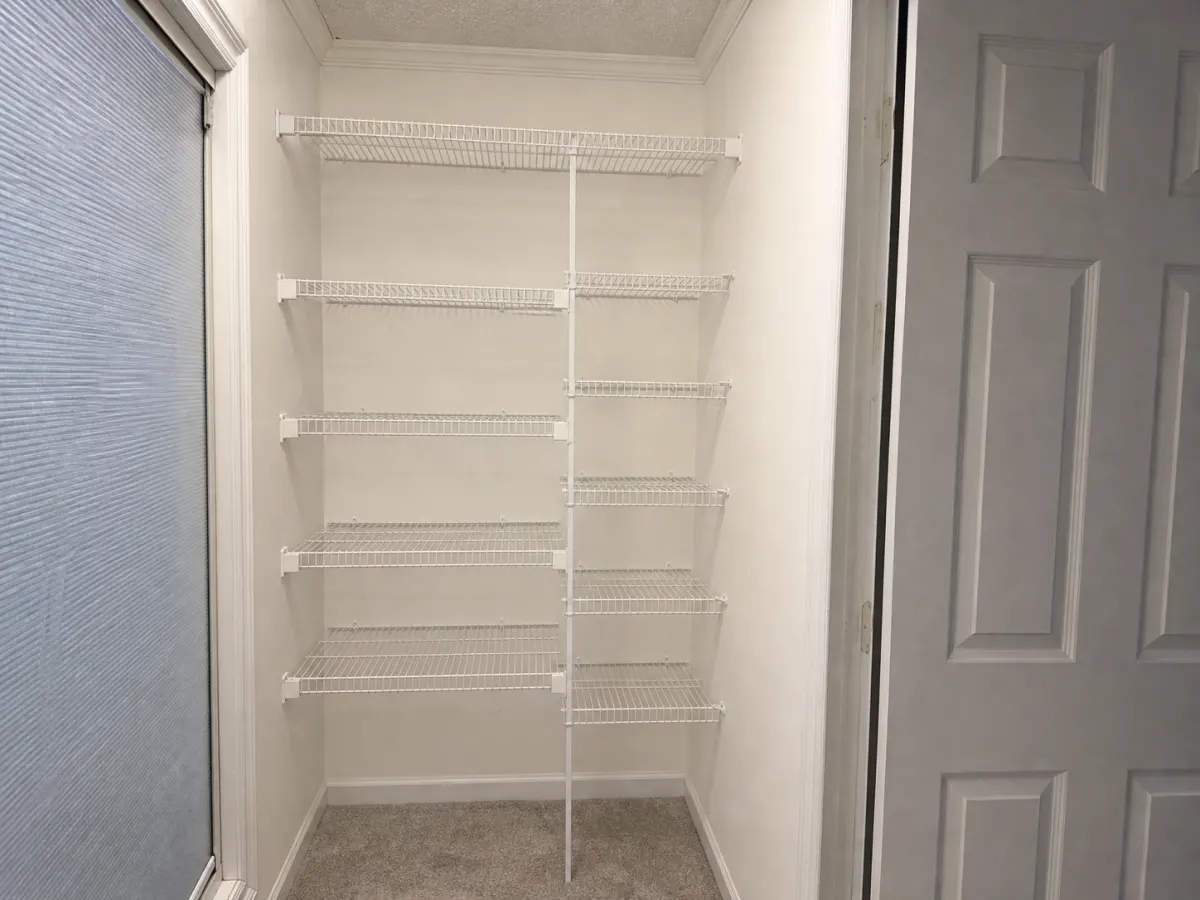 Clean empty secondary walk-in closet
